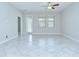 Bright living area with tile flooring, fan and door to lanai with lots of natural light at 11011 Little Blue Heron Dr, Riverview, FL 33579
