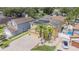 An aerial view of a well-maintained property featuring solar panels, mature trees, and a spacious yard at 1205 Sweet Gum Dr, Brandon, FL 33511