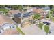 A home with solar panels, a driveway, and landscaping featuring mature shade trees and manicured lawn at 1205 Sweet Gum Dr, Brandon, FL 33511