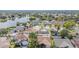 Aerial view of homes with swimming pools in a community with a lake, featuring manicured lawns and mature trees at 1205 Sweet Gum Dr, Brandon, FL 33511
