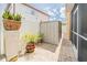 Private backyard area with a storage shed, potted plants, and an adjacent screened lanai at 1205 Sweet Gum Dr, Brandon, FL 33511