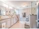 Bathroom features double vanity with white cabinets and granite countertop, and a glass-enclosed shower at 1205 Sweet Gum Dr, Brandon, FL 33511