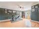 Spacious bonus room with exercise equipment, pictures, and a display case with a ceiling fan at 1205 Sweet Gum Dr, Brandon, FL 33511