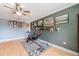 Light bonus room featuring exercise equipment and sports memorabilia, under a modern ceiling fan at 1205 Sweet Gum Dr, Brandon, FL 33511