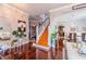 Open concept entryway with wood floors, a staircase, and views into the living room, dining room and other living areas at 1205 Sweet Gum Dr, Brandon, FL 33511