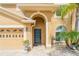 Inviting entryway featuring a modern front door, lush landscaping, and a convenient attached garage at 1205 Sweet Gum Dr, Brandon, FL 33511