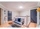 Hallway with neutral paint, stylish wainscoting, and bench seating with blue pillows and a matching blue area rug at 1205 Sweet Gum Dr, Brandon, FL 33511