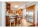Kitchen with breakfast bar, light countertops, stainless steel appliances and wood cabinets and floors at 1205 Sweet Gum Dr, Brandon, FL 33511