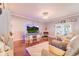 Cozy living room features an electric fireplace, TV, hardwood floors and modern decor at 1205 Sweet Gum Dr, Brandon, FL 33511