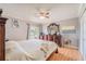Bedroom featuring a large wooden dresser with a mirror and a comfortable bed with side tables and a ceiling fan at 1205 Sweet Gum Dr, Brandon, FL 33511