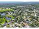 Expansive aerial view of the community with mature trees, a pond, and lush landscaping at 12405 Pathway Ct, Riverview, FL 33569