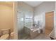 A bathroom featuring a separate tub and shower with clear glass, and tile flooring at 12405 Pathway Ct, Riverview, FL 33569