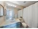 A bathroom featuring a large mirror, vanity, and shower with a curtain at 12405 Pathway Ct, Riverview, FL 33569