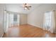 A bright bedroom features hardwood floors, neutral walls, ceiling fan, and an abundance of natural light at 12405 Pathway Ct, Riverview, FL 33569