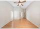A spacious bedroom featuring hardwood floors, a ceiling fan, neutral walls, and plenty of natural light at 12405 Pathway Ct, Riverview, FL 33569