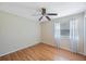 A well-lit bedroom showcasing wood floors and a window with sheer curtains at 12405 Pathway Ct, Riverview, FL 33569