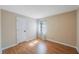 An empty bedroom with wood floors, a window, and a closet at 12405 Pathway Ct, Riverview, FL 33569