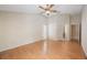 A spacious bedroom featuring hardwood floors, a ceiling fan, neutral walls, and plenty of natural light at 12405 Pathway Ct, Riverview, FL 33569