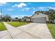 Charming one-story home boasts a well-manicured lawn, a two-car garage, and appealing architectural details at 12405 Pathway Ct, Riverview, FL 33569