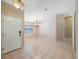 Open foyer area showcasing tiled flooring, natural light, and a modern chandelier above a large space at 12405 Pathway Ct, Riverview, FL 33569