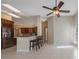 Bright, modern kitchen with stainless steel appliances, tile floors, and bar seating at 12405 Pathway Ct, Riverview, FL 33569