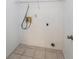 A simple laundry room with tile floors and connections for a washer and dryer at 12405 Pathway Ct, Riverview, FL 33569