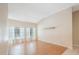 Large living room with wood floors, two windows, a vaulted ceiling, and natural light at 12405 Pathway Ct, Riverview, FL 33569
