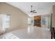 Open living room with tile flooring, a fireplace with stone surround, and lots of natural light at 12405 Pathway Ct, Riverview, FL 33569