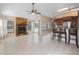 Spacious living room with fireplace, tile floors, bar seating, and an open floor plan at 12405 Pathway Ct, Riverview, FL 33569