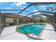 Relaxing screened pool area surrounded by greenery offering a private space to unwind in a backyard oasis at 12405 Pathway Ct, Riverview, FL 33569