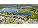 Scenic aerial view showcasing the neighborhood's homes, lush green spaces, and a beautiful lake at 12607 Pensacola Ct, Riverview, FL 33579