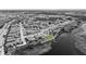 Black and white aerial view of a residential community with a highlighted property and lake at 12607 Pensacola Ct, Riverview, FL 33579