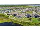An aerial view highlighting houses with a pond and green space at 12607 Pensacola Ct, Riverview, FL 33579