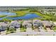 Aerial view of homes surrounding a serene lake and lush greenery in a picturesque community at 12607 Pensacola Ct, Riverview, FL 33579