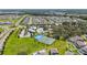 An aerial view of the community amenities with a pool, clubhouse, tennis courts, and surrounding green spaces at 12607 Pensacola Ct, Riverview, FL 33579