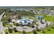 Aerial shot of the community clubhouse, pool, tennis courts, and surrounding homes with landscaping at 12607 Pensacola Ct, Riverview, FL 33579