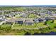 Aerial shot of home with spacious backyard, pool, lush lawn, and screened-in lanai by a pond at 12607 Pensacola Ct, Riverview, FL 33579
