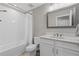 Clean bathroom featuring a shower-tub combination with tile surround, vanity, and a framed mirror at 12607 Pensacola Ct, Riverview, FL 33579