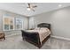 Bright bedroom featuring a plush bed, neutral decor, a ceiling fan, and windows with plantation shutters at 12607 Pensacola Ct, Riverview, FL 33579