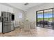 Breakfast nook with stainless steel refrigerator and outdoor lake views at 12607 Pensacola Ct, Riverview, FL 33579