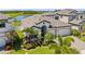 Beautiful home exterior featuring a well-manicured lawn, lush landscaping, and a three-car garage at 12607 Pensacola Ct, Riverview, FL 33579