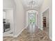 Spacious hallway with arched doorways showcasing elegant light fixtures and beautiful flooring at 12607 Pensacola Ct, Riverview, FL 33579