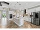 Well-designed kitchen with white cabinets, stainless steel appliances, a central island, and modern pendant lighting at 12607 Pensacola Ct, Riverview, FL 33579