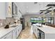 Open-concept kitchen featuring modern appliances, granite countertops, herringbone floors, and backyard views at 12607 Pensacola Ct, Riverview, FL 33579