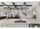 Kitchen view showcases an island with sink, pendant lighting, and wood beam ceiling details at 12607 Pensacola Ct, Riverview, FL 33579
