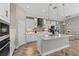Bright, modern kitchen with white cabinetry, granite countertops, stainless steel appliances, and a stylish backsplash at 12607 Pensacola Ct, Riverview, FL 33579