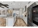 Modern kitchen with white cabinets, a stainless steel refrigerator, an island, and a stylish cooktop with range hood at 12607 Pensacola Ct, Riverview, FL 33579