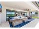 Inviting outdoor living space featuring comfortable seating, a dining area, and views of the pool and lake at 12607 Pensacola Ct, Riverview, FL 33579