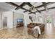 Spacious living room boasts wood beam ceilings, tile floors, and comfortable seating at 12607 Pensacola Ct, Riverview, FL 33579