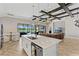 Open-concept kitchen and living area with an island, and view of the outdoor pool and patio at 12607 Pensacola Ct, Riverview, FL 33579